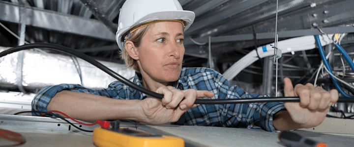 Electrician working in roof space